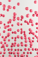 Glossy balls in viva magenta color. Abstract background. 3d rendering