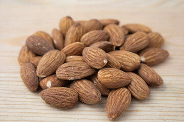 Roasted almonds on wooden background