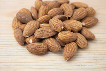 Roasted almonds on wooden background