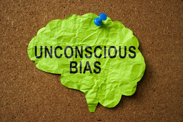 Brain made of paper with the inscription Unconscious Bias pinned to the board.