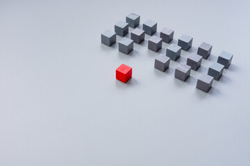 Gray cubes and one red. Stand out from the crowd concept.