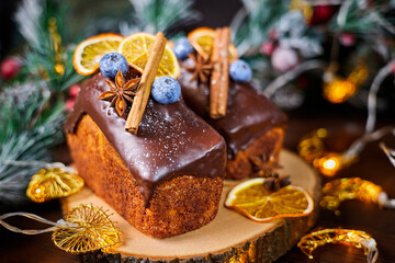 New Year's cake with delicate creamy dough and raisins decorated with spices, blueberries and dried orange slices