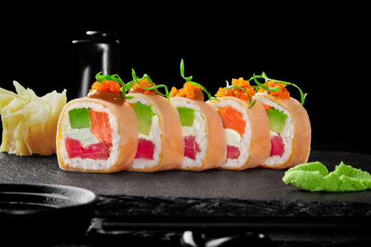 Sushi rolls in mamenori with tuna, salmon, avocado, cream cheese, tobiko