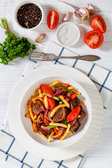 Lomo saltado, fried beef, french fries, veggies