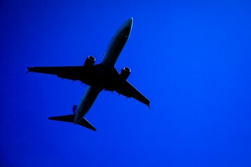 Commercial Airliner Silhouette against blue sky