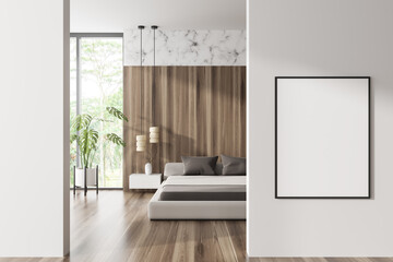 Front view on bright bedroom interior with empty white poster