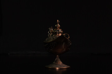 Aladdin's magic lamp isolated on black background
