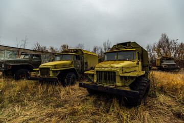 Old abandoned rusty military trucks at the base
