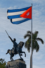 Flag of Cuba on a mast against the statue