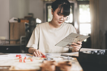 Young adult asian woman enjoying role playing tabletop and board game