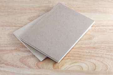 Fototapeta premium Recycled paper book on wooden background