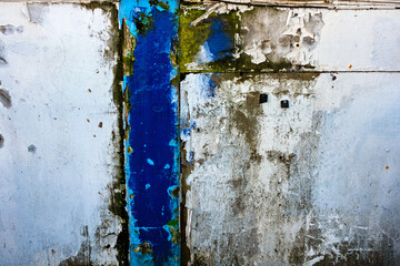 Delapidated ironwork and wood with rust and peeling paint.