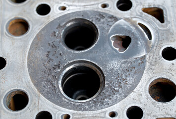 Maintenance inspection of engine valves, engine cylinder head. Repair of engine head and valves. Disassembled machine engine at modern auto service