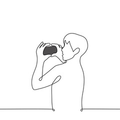 man shoots on phone - one line drawing vector. concept mobile shooting horizontal photo or video