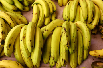 Banana bunches on grocery shelf.