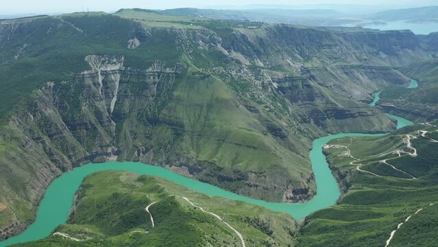 Stunning view of green deep canyon with turquoise river. Sulakskiy canyon in Dagestan Republic. Drone panoramic view
