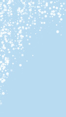 Fototapeta na wymiar Beautiful snowfall christmas background. Subtle flying snow flakes and stars on light blue winter backdrop. Beautiful snowfall overlay template. Vertical vector illustration.