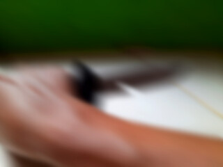 Abstract blurred background with a composition of green at the top, white in the middle, and brown at the bottom.
