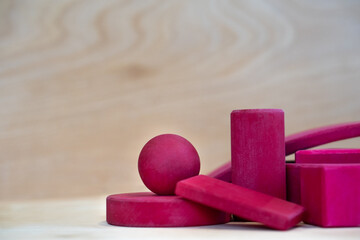 Red Wooden Shapes against Wood Grain backdrop - Left Negative space