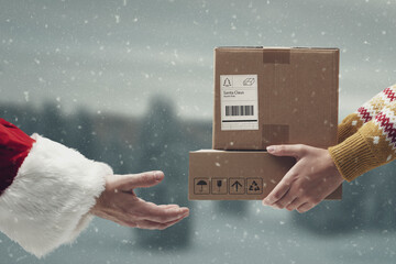 Santa Claus receiving boxes hands close up