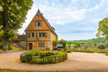 One painted timber frame house in a beautiful public garden, surrounded by trees and lawns,...