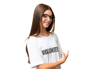 Teenager volunteer caucasian girl over isolated background pointing back