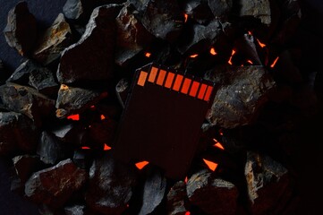 The micro sd card lies on hot coals. Close-up