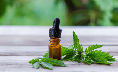 hemp oil in jars close-up. On a wooden background.