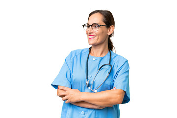 Middle-aged nurse woman over isolated background happy and smiling