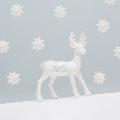 Minimal abstract aesthetic Xmas greeting card with white reindeer and cookies in the shape of...