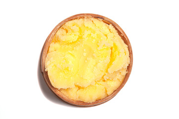 Ghee in wooden bowl isolated on white background