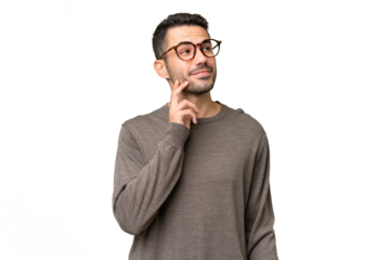 Young handsome caucasian man over isolated background thinking an idea while looking up