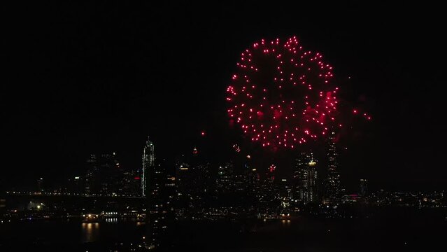 New Year Fireworks in Sydney over city CBD high-rise building landmarks.
