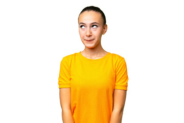 Young Arab woman over isolated background having doubts while looking up