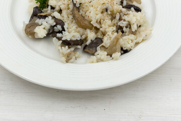 Plate of mushroom risotto, garnished with Oyster mushrooms Pleurotus ostreatus .
