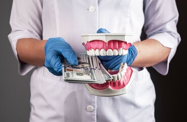 Expensive dentistry concept. Dentist with dollars money for teeth health