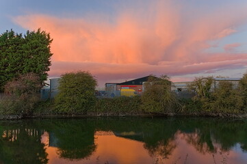 Fototapeta na wymiar sunset clouds over the river in autumn