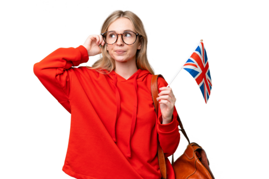 Young hispanic woman holding an United Kingdom flag over isolated background having doubts and thinking
