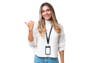Young Uruguayan woman with ID card over isolated background pointing to the side to present a product