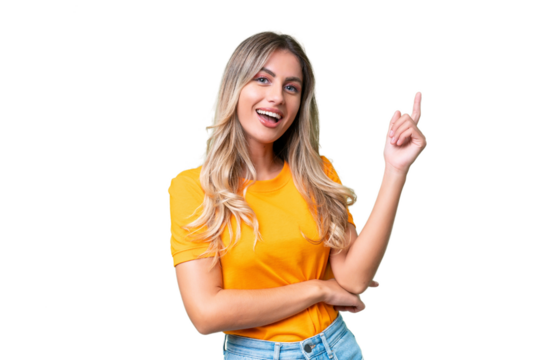 Young Uruguayan woman over isolated background happy and pointing up