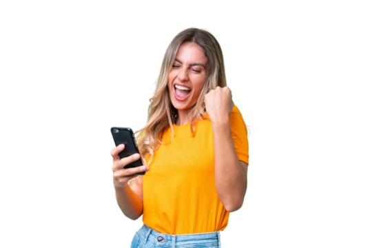 Young Uruguayan woman over isolated background with phone in victory position