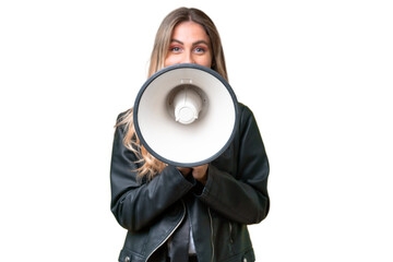 Business pretty Uruguayan woman wearing a biker jacket over isolated background shouting through a megaphone