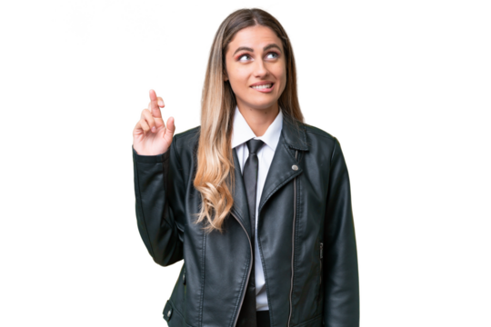 Business pretty Uruguayan woman wearing a biker jacket over isolated background with fingers crossing and wishing the best
