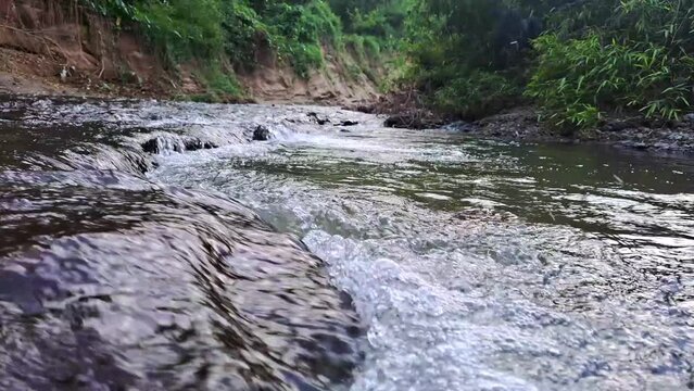 4K footage of relaxing flowing water of a river with cascading sound.