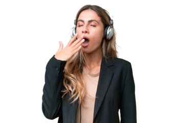 Telemarketer pretty Uruguayan woman working with a headset over isolated background yawning and covering wide open mouth with hand