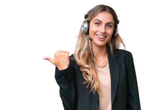 Telemarketer pretty Uruguayan woman working with a headset over isolated background pointing to the side to present a product