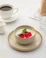 Portion of healthy sweet porridge with banana and jam