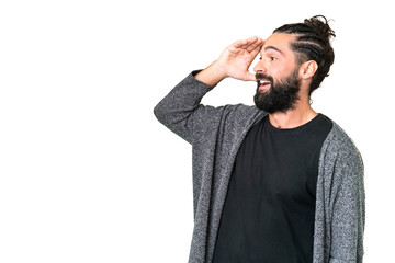 Young man with beard over isolated chroma key background with surprise expression while looking side