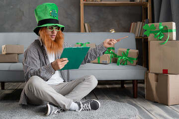 Man in leprechaun hat preparing post shipping fast St.Patricks day delivery parcels sitting in home...