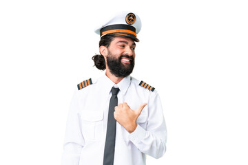 Airplane caucasian pilot man over isolated chroma key background pointing to the side to present a product